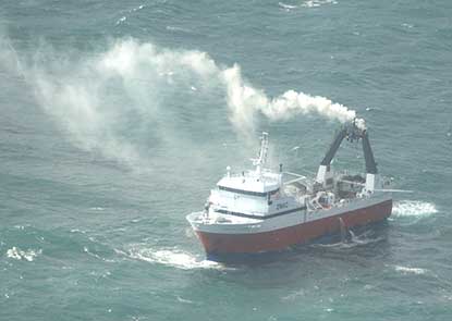 a fishing vessel at sea on fire